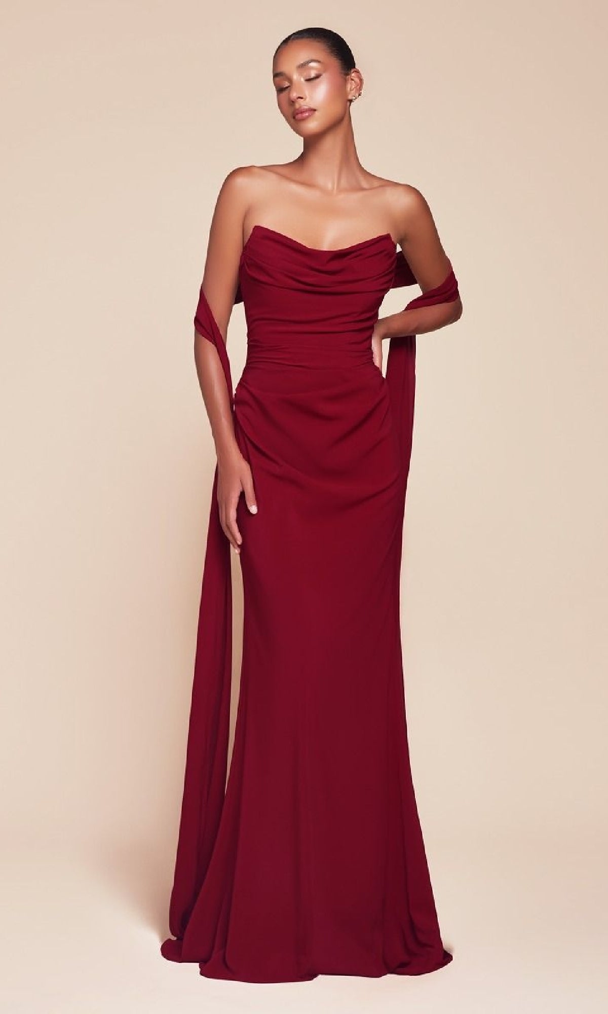 A woman poses against a beige background wearing the Ladivine 7433 Multi-Way Long Chiffon Prom Dress, styled strapless with draped chiffon fabric over her arms.